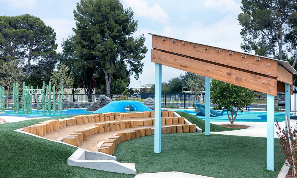 Modern playground with slides, climbing structures, and shaded seating in Camarillo.