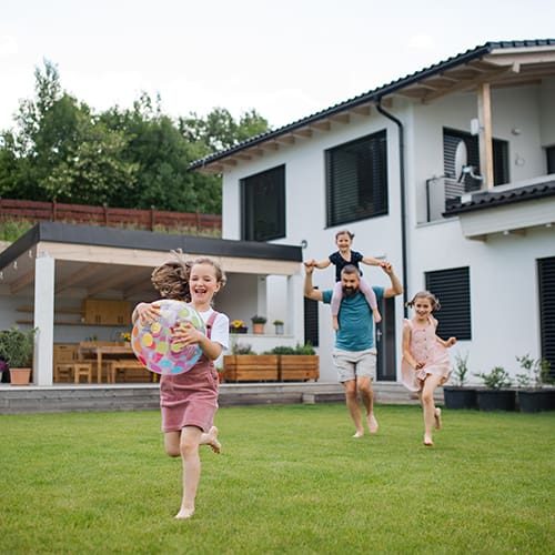 Family enjoying outdoor play in front of a modern house in Camarillo, California.