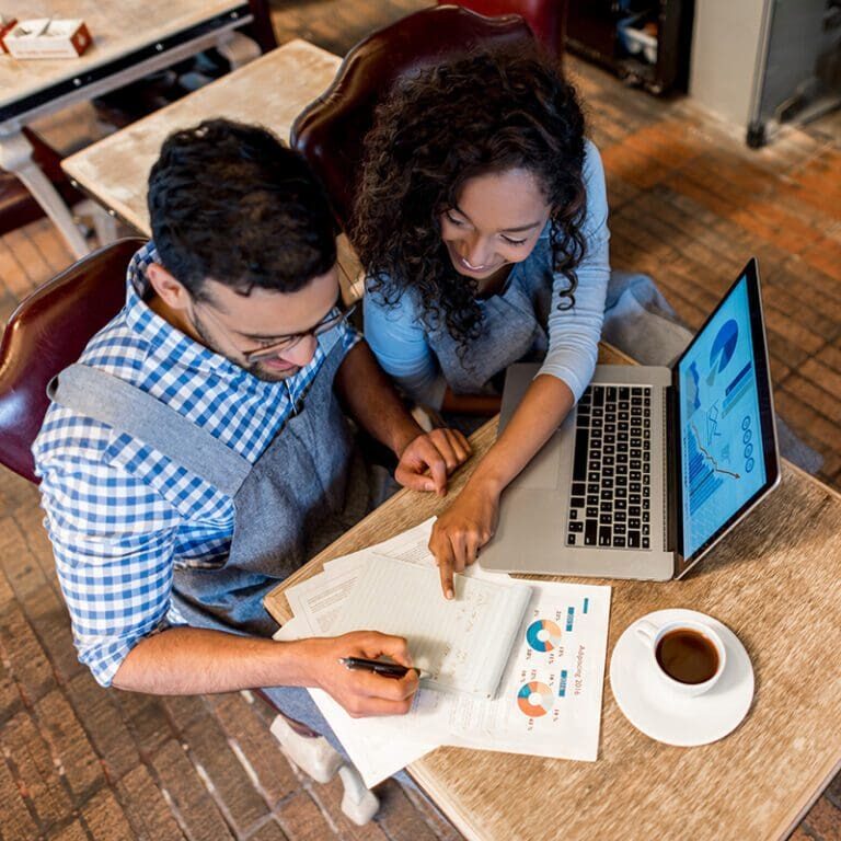 Happy business partners working together at a restaurant